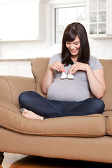 Image showing Happy Pregnant Woman with Baby Shoes