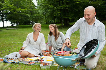 Image showing Friends Having Meal At An Outdoor Picnic