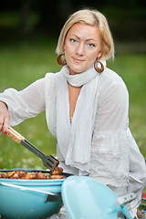 Image showing Female Preparing Food On Barbecue