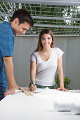 Image showing Female Architect Working On Blueprint