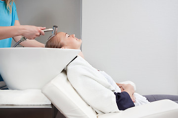 Image showing Young Woman Having Hair Rinsed