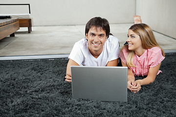 Image showing Couple With Laptop On Rug