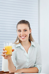 Image showing Happy Businesswoman Holding Orange Juice