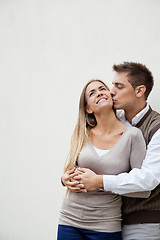 Image showing Young Man Kissing Girlfriend