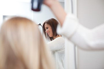 Image showing Stylist Drying Womans Hair