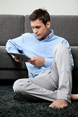 Image showing Relaxed Man Using Digital Tablet