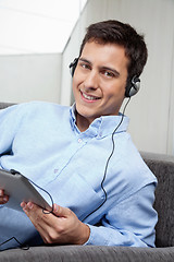 Image showing Young Man Listening Music On Digital Tablet