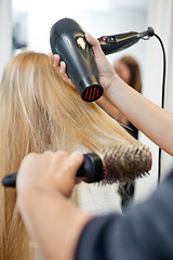 Image showing Stylist Drying Woman's Hair In Hairdresser Salon