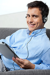 Image showing Happy Man Listening Music On Digital Tablet