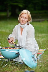 Image showing Woman Preparing Food On Barbecue