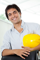 Image showing Architect Holding Hardhat