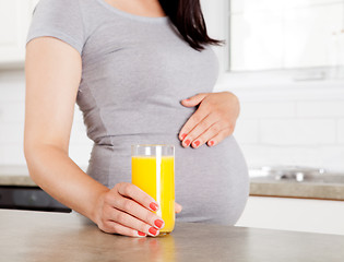 Image showing Pregnant Woman Holding Orange Juice