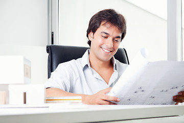 Image showing Happy Architect Looking at Blueprints