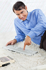 Image showing Geek With Computer Keyboard And Cassette Player