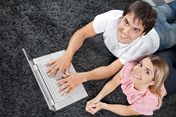 Image showing Couple On Rug With Laptop