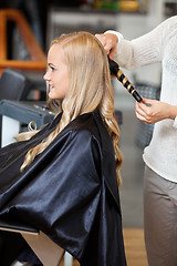 Image showing Woman At Parlor Making Her Hair Curly