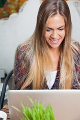 Image showing Woman Using Laptop in Cafe