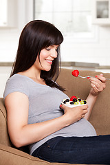 Image showing Pregnant Woman Eating Fruit