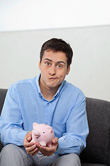 Image showing Businessman With Piggybank