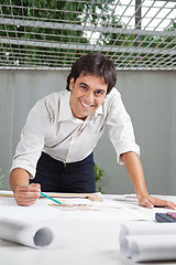 Image showing Male Architect Working On Blueprint