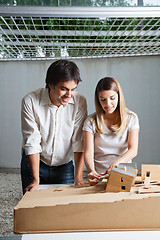 Image showing Female Architect Working On Model House