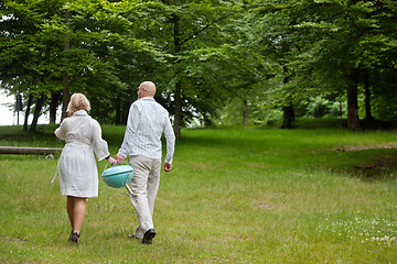 Image showing Couple Walking With Portable Barbecue