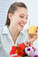 Image showing Jovial Businesswoman Holding Orange Juice