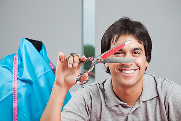 Image showing Happy Dressmaker Holding Scissor