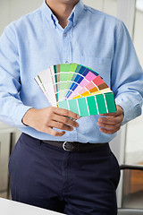 Image showing Interior Designer Holding Color Swatches