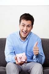 Image showing Man with Piggy Bank