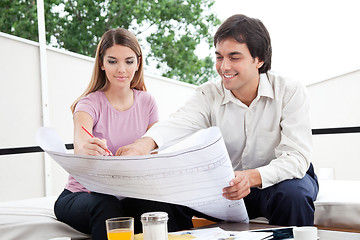 Image showing Two Architect Working on Blueprints