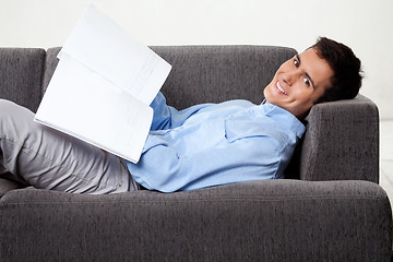 Image showing Young Man Holding Magazine