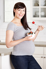 Image showing Pregnant Woman Eating Healthy Snack