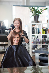 Image showing Stylist Drying Woman's Hair