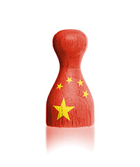 Image showing Wooden pawn with a painting of a flag