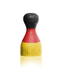 Image showing Wooden pawn with a painting of a flag