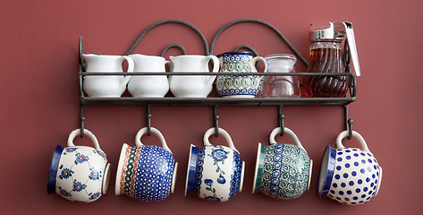 Image showing Cups on a kitchen wall
