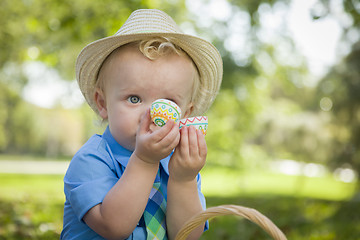 Image showing Cute Little Boy Enjoying His Easter Eggs Outside in Park