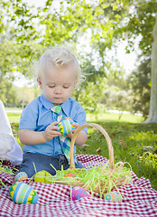 Image showing Cute Little Boy Enjoying His Easter Eggs Outside in Park