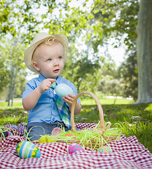 Image showing Cute Little Boy Enjoying His Easter Eggs Outside in Park