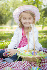 Image showing Cute Young Girl Wearing Hat Enjoys Her Easter Eggs