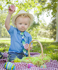 Image showing Cute Little Boy Enjoying His Easter Eggs Outside in Park