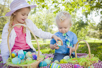 Image showing Cute Young Brother and Sister Enjoying Their Easter Eggs Outside