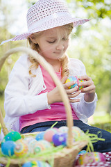 Image showing Cute Young Girl Wearing Hat Enjoys Her Easter Eggs