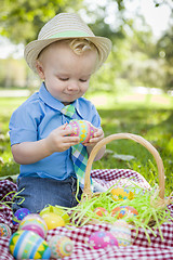 Image showing Cute Little Boy Enjoying His Easter Eggs Outside in Park