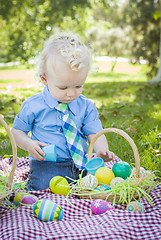 Image showing Cute Little Boy Enjoying His Easter Eggs Outside in Park