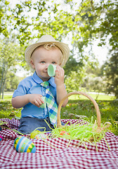 Image showing Cute Little Boy Enjoying His Easter Eggs Outside in Park