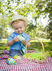 Image showing Cute Little Boy Enjoying His Easter Eggs Outside in Park