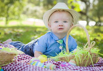 Image showing Cute Little Boy Smiles With Easter Eggs Around Him