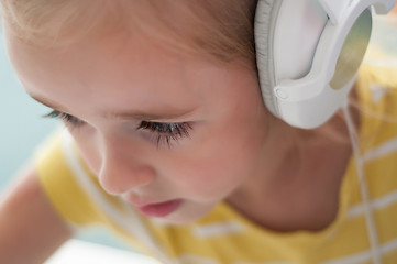 Image showing Little blond girl in headphones